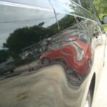 Before and after photographs of a damaged black Volkswagon Jetta that was repaired by Elite Paint & Body Shop in West Palm Beach, Florida.